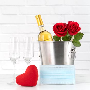 Valentine's Day celebration with wine, bouquet and face mask protection concept during this hard time.