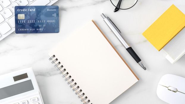 Top view of estimating and paying house tax with calculator and credit card from internet.