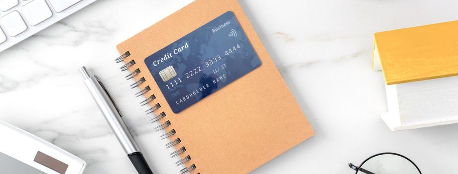 Top view of estimating and paying house tax with calculator and credit card from internet.