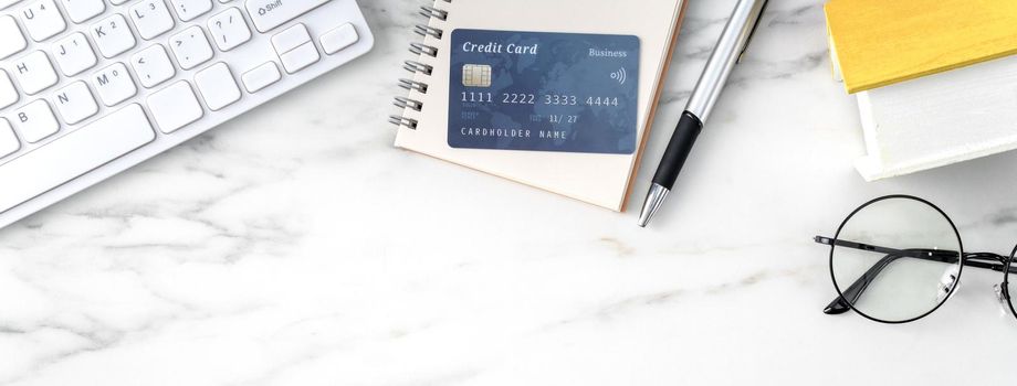 Top view of estimating and paying house tax with calculator and credit card from internet.
