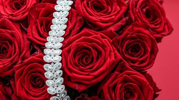 Gemstone jewellery, wedding fashion and luxe shopping concept - Luxury diamond bracelet and bouquet of red roses, jewelry love gift on Valentines Day and romantic holidays present