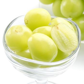 Close up of beautiful Shrine Muscat green grape in a glass cup isolated on white background, clipping path cut out.