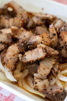 Close up of delicious Taiwanese salted pork food with onion in restaurant.