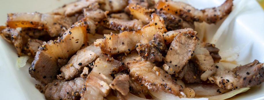 Close up of delicious Taiwanese salted pork food with onion in restaurant.