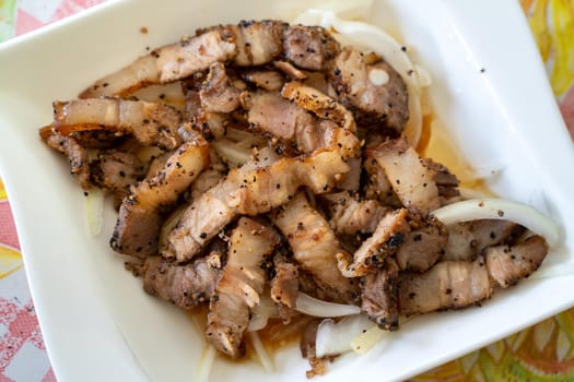 Close up of delicious Taiwanese salted pork food with onion in restaurant.