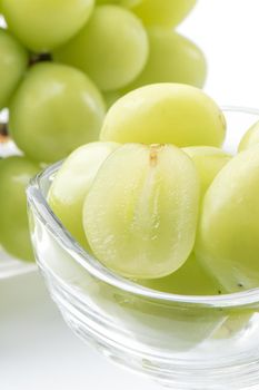 Close up of beautiful Shrine Muscat green grape in a glass cup isolated on white background, clipping path cut out.