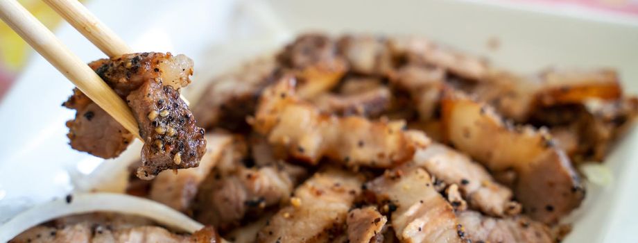 Close up of delicious Taiwanese salted pork food with onion in restaurant.