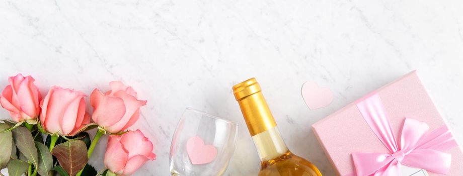 Giftbox and pink rose flower on marble white table background for Valentine's Day holiday gift design concept.