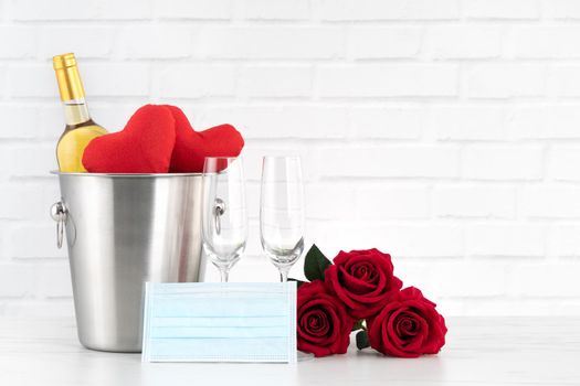 Valentine's Day celebration with wine, bouquet and face mask protection concept during this hard time.