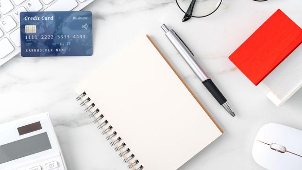Top view of estimating and paying house tax with calculator and credit card from internet.