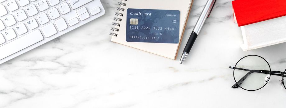 Top view of estimating and paying house tax with calculator and credit card from internet.