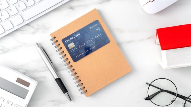 Top view of estimating and paying house tax with calculator and credit card from internet.