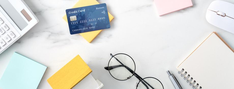 Top view of estimating and paying house tax with calculator and credit card from internet.