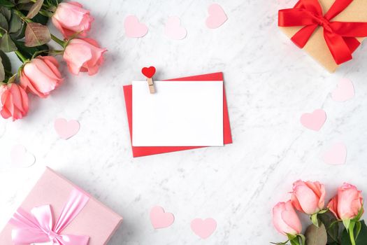 Valentine's Day design concept background with pink rose flower, gift box and card on marble white background
