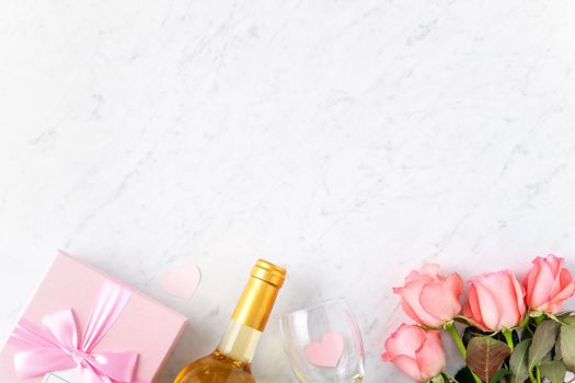 Giftbox and pink rose flower on marble white table background for Valentine's Day holiday gift design concept concept.