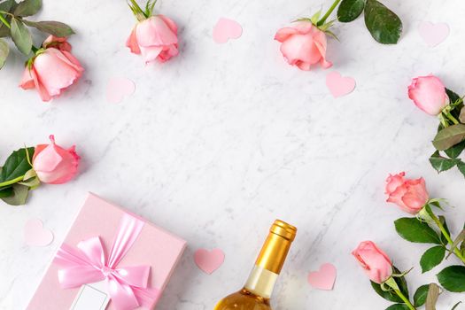 Giftbox and pink rose flower on marble white table background for Valentine's Day holiday gift design concept concept.