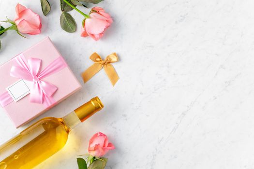 Giftbox and pink rose flower on marble white table background for Valentine's Day holiday gift design concept concept.