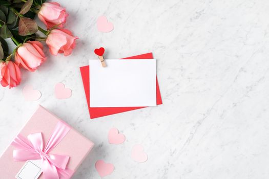Valentine's Day design concept background with pink rose flower and gift box on marble white background