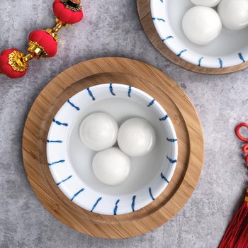 Top view of big tangyuan yuanxiao (glutinous rice dumpling balls) for Chinese lunar new year festival food, words on the golden coin means the Dynasty name it made.