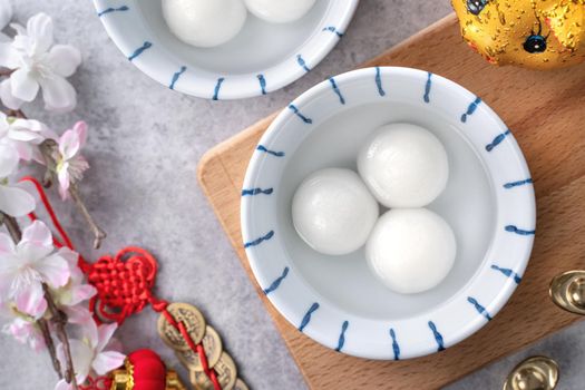 Top view of big tangyuan yuanxiao (glutinous rice dumpling balls) for Chinese lunar new year festival food, words on the golden coin means the Dynasty name it made.