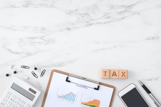 Top view of reading the overview and calculating, paying tax with smart phone from internet.