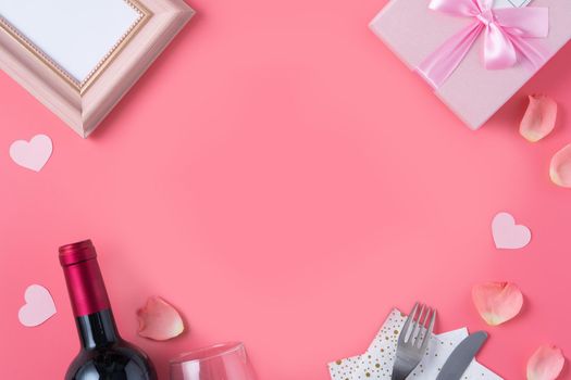 Valentine's Day design concept background with pink petals and gift box on pink background