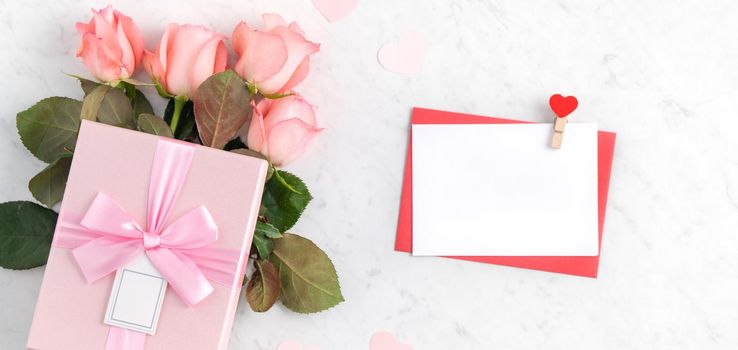 Valentine's Day design concept background with pink rose flower and gift box on marble white background