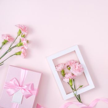 Mother's Day, Valentine's Day background design concept, beautiful pink carnation flower bouquet on pastel pink table, top view, flat lay, copy space.