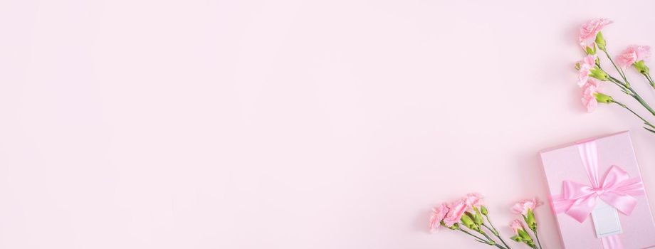 Mother's Day, Valentine's Day background design concept, beautiful pink carnation flower bouquet on pastel pink table, top view, flat lay, copy space.