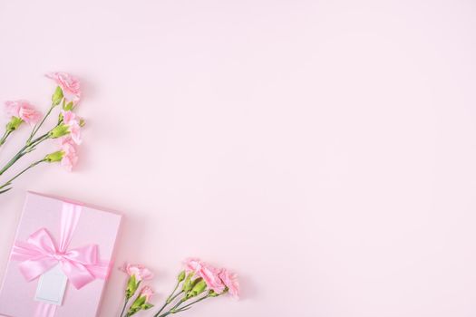 Mother's Day, Valentine's Day background design concept, beautiful pink carnation flower bouquet on pastel pink table, top view, flat lay, copy space.