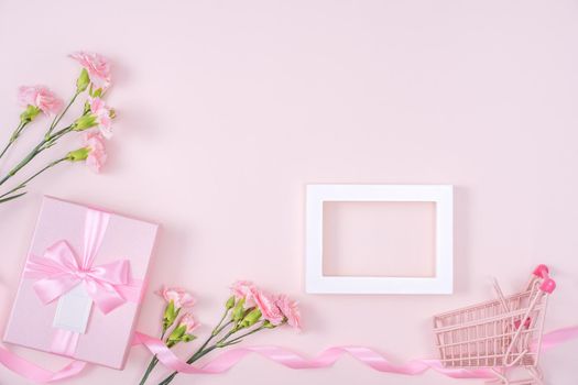 Mother's Day, Valentine's Day background design concept, beautiful pink carnation flower bouquet on pastel pink table, top view, flat lay, copy space.