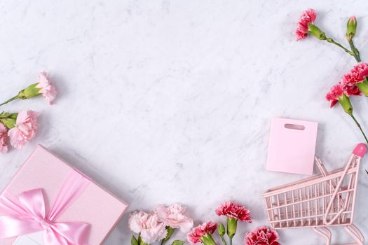 Top view of Mother's Day background design concept with carnation flower bouquet on marble table