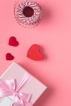 Valentine's Day design concept background with rose flower and gift box on pink background