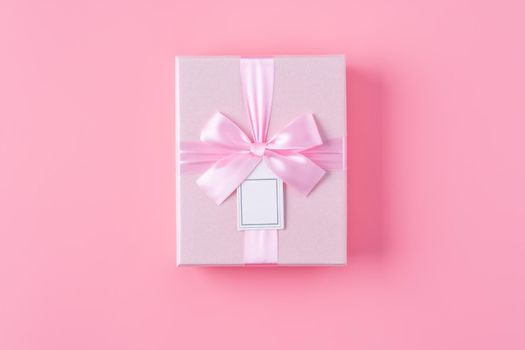 Valentine's Day design concept background with rose flower and gift box on pink background