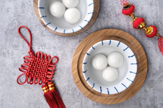 Top view of big tangyuan yuanxiao (glutinous rice dumpling balls) for Chinese lunar new year festival food, words on the golden coin means the Dynasty name it made.