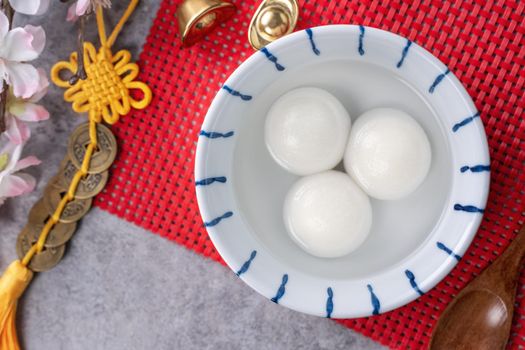 Top view of big tangyuan yuanxiao (glutinous rice dumpling balls) for Chinese lunar new year festival food, words on the golden coin means the Dynasty name it made.