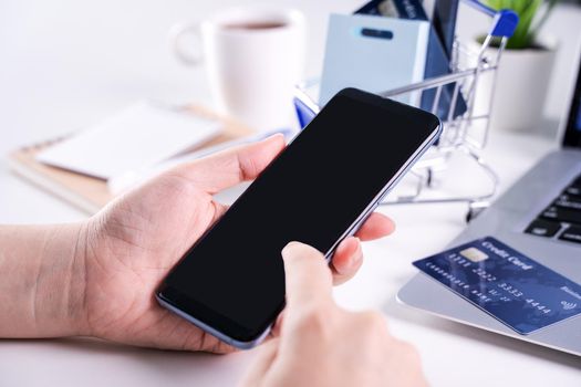 Woman using holding smart mobile phone staying home online electronic payment