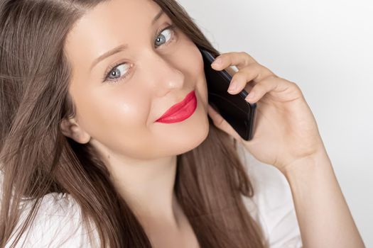 Happy smiling woman calling on smartphone, portrait on white background. People, technology and communication concept.