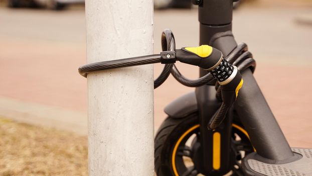 Electric scooter with a combination lock. Anti-theft protection. Close up photo