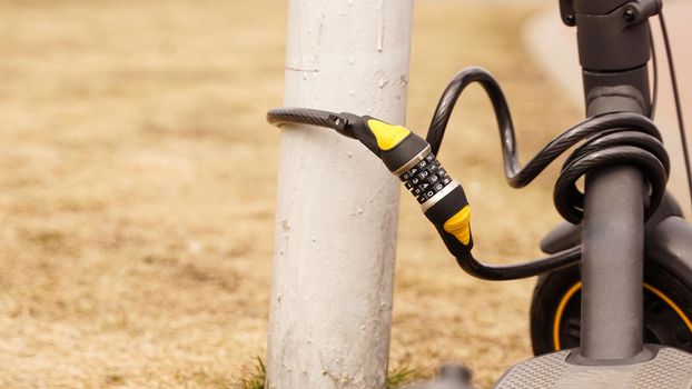 Electric scooter with a combination lock. Anti-theft protection. Close up photo