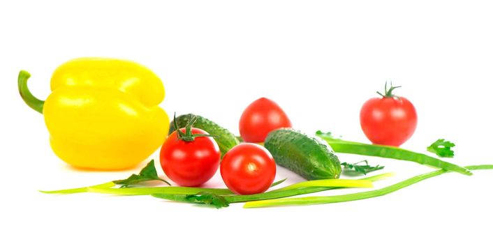 Composition of vegetables on the white background - tomatoes, cucumbers and green onions