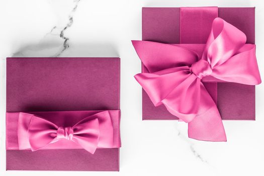 Birthday, wedding and girly branding concept - Pink gift box with silk bow on marble background, girl baby shower present and glamour fashion gift for luxury beauty brand, holiday flatlay art design