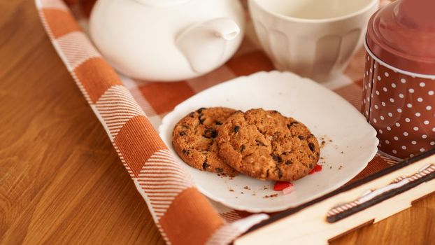 Homemade oatmeal cookies, cup of coffee on a wooden tray. The concept of having breakfast in bed and a pleasant morning