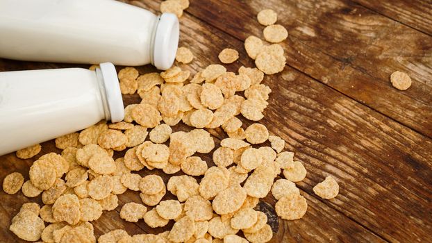 Fresh Milk in Glasses Bottles with cornflakes, Dairy Produce Concept of Breakfast on Wood Table Background, Country Rustic Still Life Style