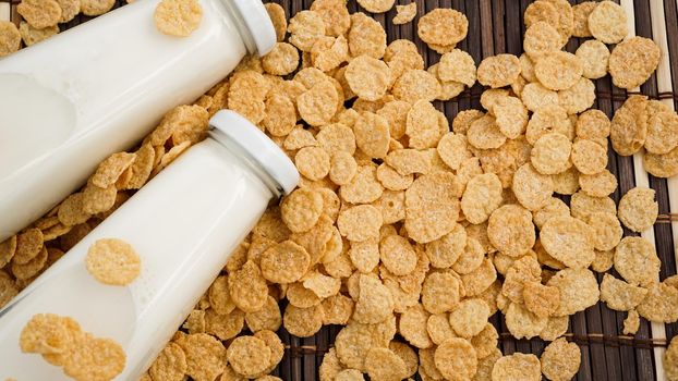 Fresh Milk in Glasses Bottles with cornflakes, Dairy Produce Concept of Breakfast on Wood Table Background, Country Rustic Still Life Style