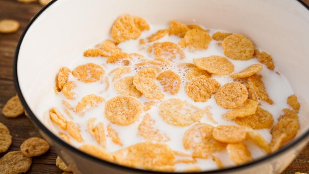 Eco healthy food background. Corn flakes with milk. Flakes in milk in a white bowl. Healthy food and fresh breakfast