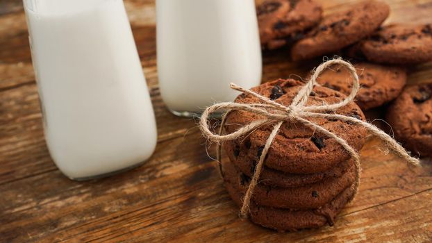 Chocolate cookie with milk on wooden table. Homemade cookies. The concept of natural and healthy nutrition. Bakery products