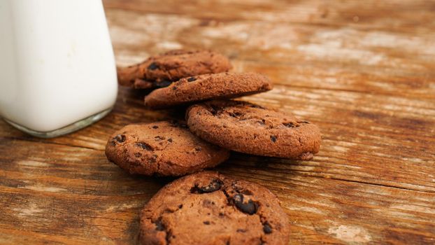 Chocolate cookie with milk on wooden table. Homemade cookies. The concept of natural and healthy nutrition. Bakery products