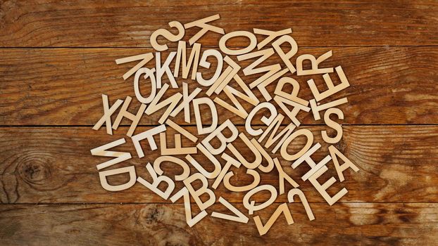 Wooden letters on wooden background. The letters of the English alphabet. Each letter is repeated two times.