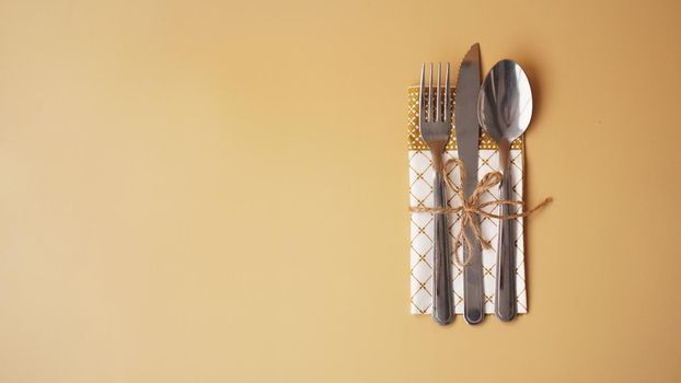 Festive table setting on simple gold background. Beautiful flat lay arrangement.